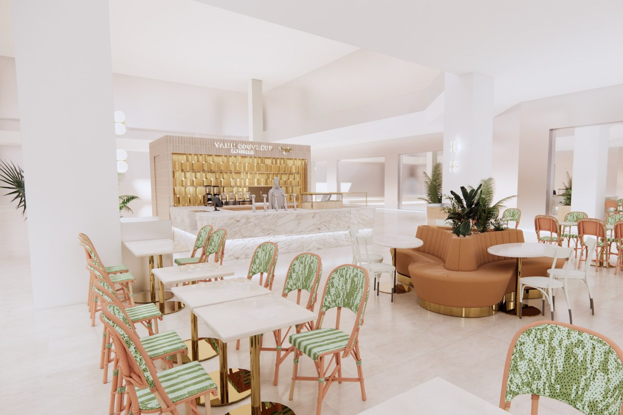 Modern restaurant interior with tables, chairs, and a bar area.